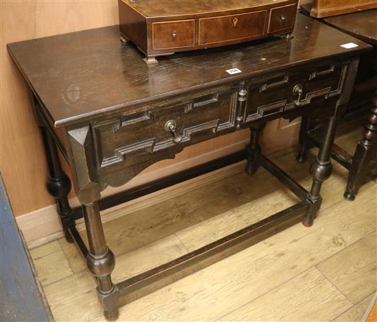 An ebonised side table, W.91cm